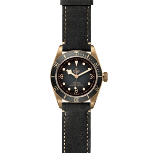 Tudor bronze diving watch with black ceramic bezel and leather strap for stylish functionality.