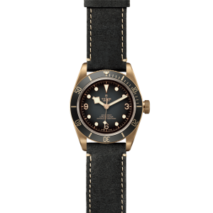 Tudor bronze diving watch with black ceramic bezel and leather strap for stylish functionality.