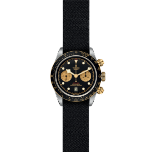 Tudor chronograph watch with black dial and gold accents, combining elegance and sporty functionality.