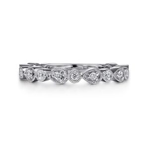 Elegant white gold ring with teardrop and round-cut diamonds, showcasing subtle luxury and sophistication.
