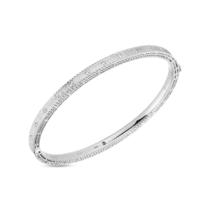 Elegant silver bangle with intricate patterns on a black background, perfect for any occasion.
