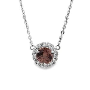 Elegant pendant necklace featuring a warm gemstone surrounded by a halo of sparkling diamonds.