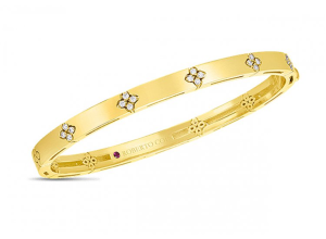 Elegant gold bangle with floral diamond motifs and a signature ruby by Roberto Coin.