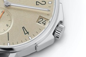 Luxurious gold wristwatch featuring a sunburst dial, black numerals, and a vibrant orange seconds hand.