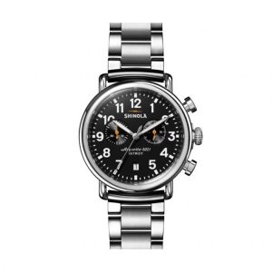 Shinola stainless steel watch with black dial, chronograph functions, and elegant bracelet design.