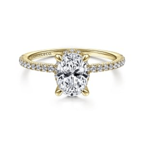 Elegant yellow gold engagement ring featuring a stunning oval-cut diamond with accent stones.