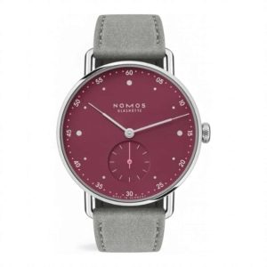 NOMOS Glashütte watch features a burgundy dial and gray leather strap for a modern, elegant style.