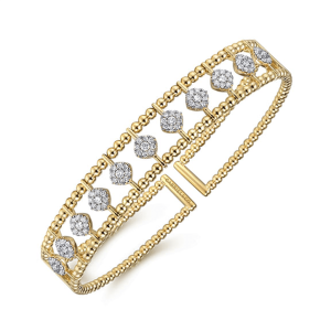 Elegant yellow gold bangle bracelet adorned with diamonds, perfect for glamorous occasions or everyday wear.
