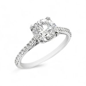 Stunning engagement ring featuring a sparkling round diamond and delicate accent stones in platinum.