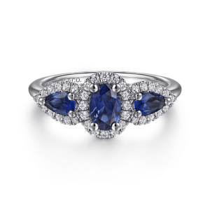 Elegant sapphire ring with diamond halo in white gold, perfect for engagement or special occasions.