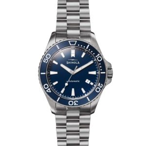 Shinola stainless steel dive watch with blue dial, automatic movement, and rotating bezel.
