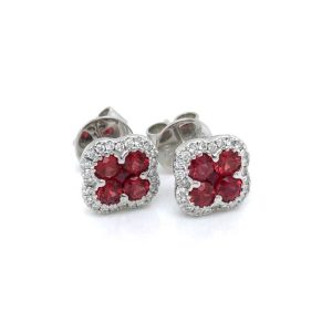 Elegant floral stud earrings with vibrant red gemstones and sparkling clear accents in silver.
