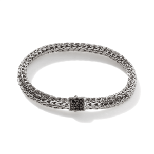 Elegant woven metal bracelet with a gemstone clasp, perfect for casual or formal occasions.