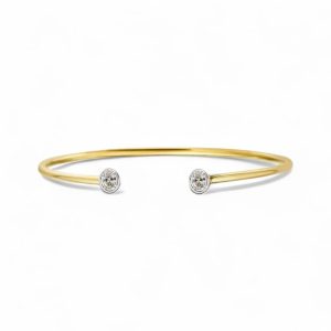 Elegant gold cuff bracelet with sparkling stone accents, perfect for casual or formal wear.