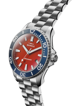 Shinola automatic watch features a striking red dial and stainless steel bracelet for modern elegance.