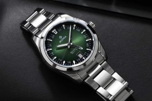 Elegant stainless steel watch with a deep green dial and luminous markers for style and functionality.