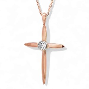Elegant rose gold cross pendant with diamond, minimalist design, perfect accessory for faith and style.
