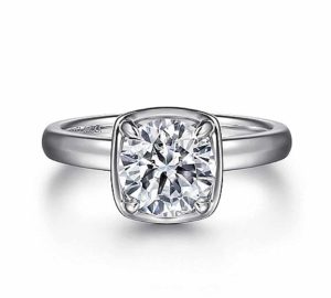 Elegant engagement ring featuring a brilliant round diamond in a sleek white gold setting.