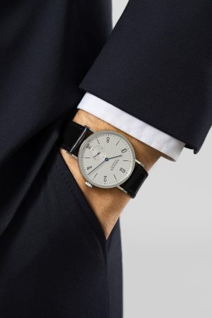 Elegant watch on a tailored suit, showcasing sophistication and timeless style.