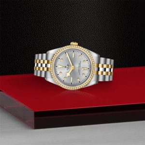 Elegant luxury watch with gold and silver tones, diamond accents, and a striking design.
