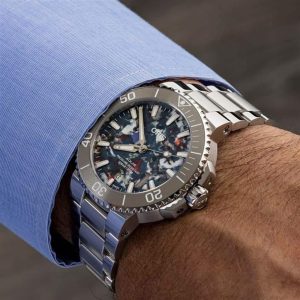 Stylish Oris watch on a wrist in a light blue dress shirt, showcasing luxury and functionality.