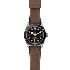 Tudor diving watch with steel case, black bezel, and brown leather strap for sophisticated adventures.