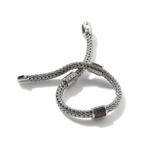 Intricate silver bracelet featuring a woven design and elegant gemstone accents for versatile style.