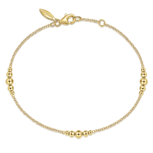 Elegant gold bracelet with polished beads, perfect for casual or formal occasions.