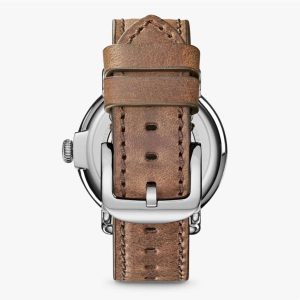 Elegant stainless steel watch with distressed leather strap showcasing vintage charm and modern design.