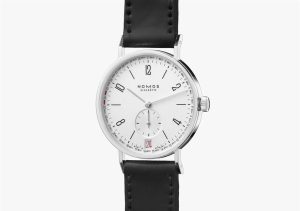 Elegant Nomos watch with stainless steel case, minimalist design, and leather strap.