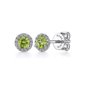 Elegant peridot stud earrings with sparkling halo accents and polished silver setting.