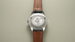Detailed close-up of a limited edition stainless steel watch with leather strap, 2022.