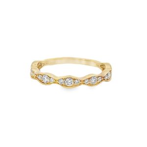 Elegant gold ring with sparkling gemstones, featuring intricate detailing and a contemporary design.