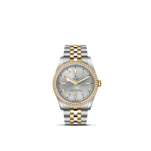 Tudor luxury watch with diamond bezel, silver dial, and gold accents for elegant style.
