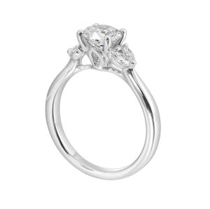 Elegant engagement ring featuring a round diamond and marquise side stones in white metal.