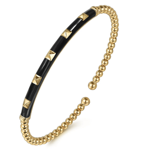 Elegant black and gold cuff bracelet with pyramid studs and polished spheres, perfect for any occasion.