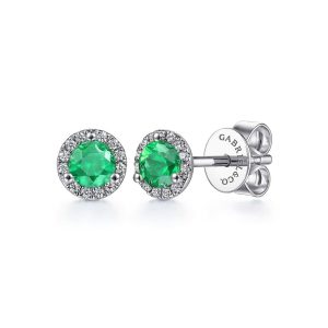 Elegant emerald stud earrings with diamond halos in silver or white gold.