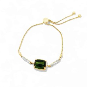 Elegant gold bracelet featuring a deep green cushion-cut gemstone and sparkling crystals.
