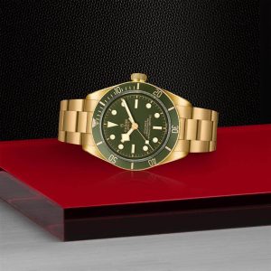 Elegant Tudor gold watch with green dial, perfect for luxury and adventure lovers.