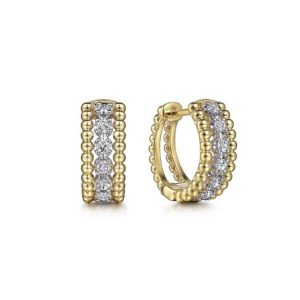 Elegant yellow gold hoop earrings with textured beads and sparkling gemstones for versatile style.