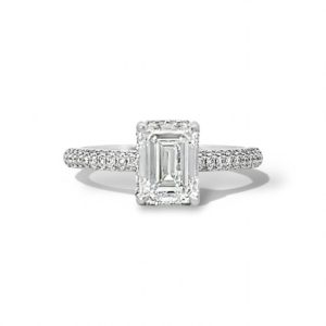 Elegant emerald-cut diamond engagement ring with pave-set diamonds on a white metal band.