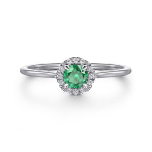 Stunning green gemstone halo ring with diamonds in elegant white gold setting.