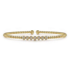 Elegant gold cuff bracelet with sparkling stones, perfect for versatile and stylish accessorizing.