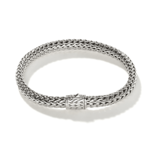 Elegant silver woven bracelet showcasing intricate design and craftsmanship in modern jewelry.