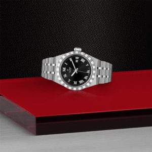 Elegant stainless steel watch with black dial on a vibrant red background.