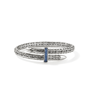 Elegant silver bracelet with woven design and blue gemstone centerpiece for stylish accessories.