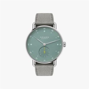 Minimalist NOMOS Glashütte watch with a green dial, silver case, and gray leather strap.