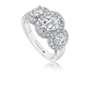 Three-stone diamond ring with halo, elegant platinum design by LAmour Creations.
