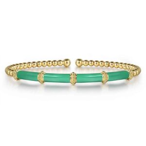 Elegant green stone cuff bracelet with intricate golden accents, perfect for any occasion.