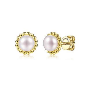 Elegant pearl earrings with a textured gold setting, perfect for any occasion.